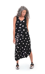 Load image into Gallery viewer, Front full body view of a woman wearing the alembika Lia Spotted Jersey Hi-Low Maxi Dress. This sleeveless dress is black with white spiral circles all over it. The front has a scoop neck and a front, right-sided draped pocket. The hem is asymmetrical.
