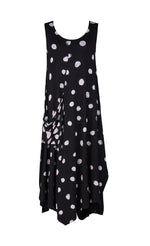 Load image into Gallery viewer, Front view of the alembika Lia Spotted Jersey Hi-Low Maxi Dress. This sleeveless dress is black with white spiral circles all over it. The front has a scoop neck and a front, right-sided draped pocket. The hem is asymmetrical.
