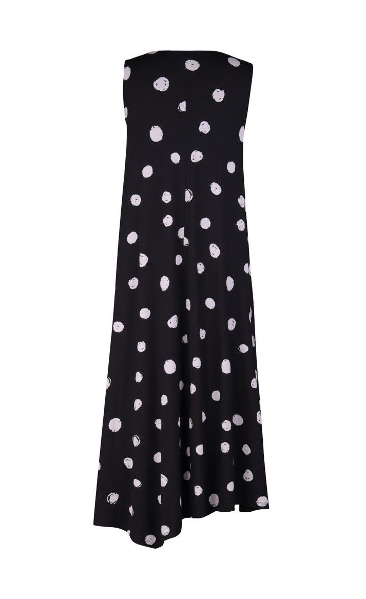 Back view of the alembika Lia Spotted Jersey Hi-Low Maxi Dress. This sleeveless dress is black with white spiral circles all over it. The back has an asymmetrical, longer hem.