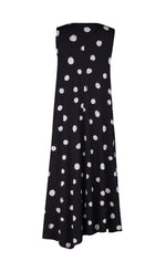 Load image into Gallery viewer, Back view of the alembika Lia Spotted Jersey Hi-Low Maxi Dress. This sleeveless dress is black with white spiral circles all over it. The back has an asymmetrical, longer hem.
