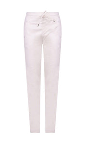 Front  view of the alembika stretch denim pant. This pant is white with two front slant pockets and a drawstring waistband. The pants have a relaxed skinny silhouette.