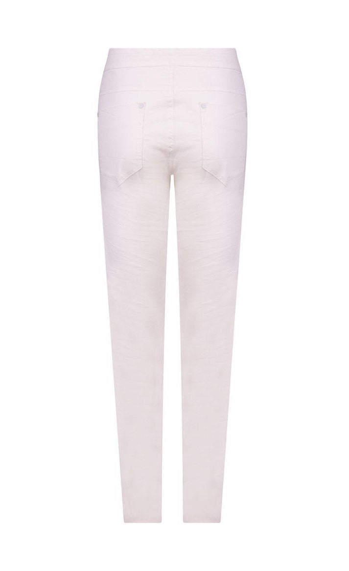 Back view of the alembika stretch denim pant. This pant is white with back pockets and a relaxed skinny silhouette.