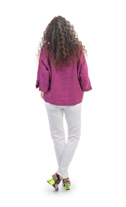 Back full body view of a woman wearing a pink top and the alembika stretch denim pant. This pant is white with a relaxed skinny silhouette.