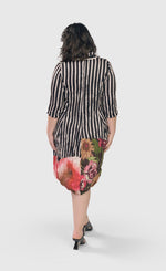 Load image into Gallery viewer, Back full body view of a woman wearing the alembika sunset wonderful dress. This dress has black and white striped print and a floral printed bottom. The dress has 3/4 length sleeves and a hem that sits at the knees.
