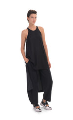 Load image into Gallery viewer, Front full body view of a woman wearing the alembika tekbika high low top with the alembika tekbika riding pant. The black top is sleeveless and solid black in the front.
