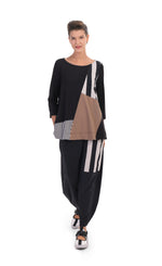 Load image into Gallery viewer, Front full body view of a woman wearing the alembika tekbika mixed print top. This top has 3/4 length sleeves and blocking of black and white stripes and mocha colored patches. On the bottom she is wearing a wide leg pant with a black and white striped patch.
