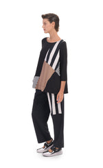Load image into Gallery viewer, Front, left side full body view of a woman wearing the alembika tekbika mixed print top. This top has 3/4 length sleeves and blocking of black and white stripes and mocha colored patches. On the bottom she is wearing a wide leg pant with a black and white striped patch.

