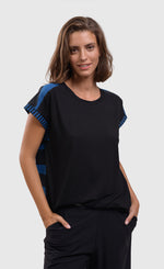 Load image into Gallery viewer, Front top half view of a woman wearing the alembika tekbika ocean cap sleeve top. This top is black in the front with blue and black stripes on the back. The top has short cap sleeves and a round neck.
