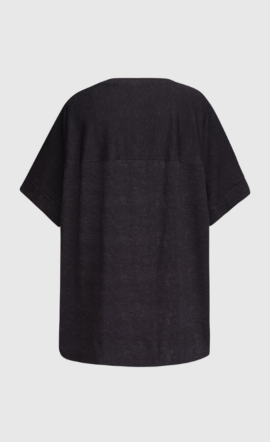 Back view of the alembika circles top. This top is a washed black with solid black back and solid black raglan sleeves.
