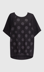 Load image into Gallery viewer, Front view of the alembika circles top. This top is a washed black with solid black short raglan sleeves and a grey dotted print on the torso.

