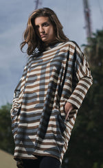 Load image into Gallery viewer, Front top half view of a woman wearing the Alembika Urban Clustur Cocoon Dress. This dress is cream and brown striped with a gray graffiti print all over it. The dress has a cocoon shape that tapers in at the knees. It has drop shoulder, long dolman sleeves and a mock neck.
