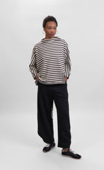 Load image into Gallery viewer, Front full body view of a woman wearing the alembika urban striped top and the alembike urban french terry punto pant. The wide pant is black.
