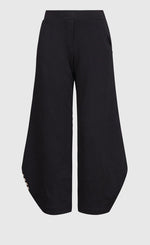 Load image into Gallery viewer, Front view of the alembika urban french terry punto pant. The wide pant is black with an elastic waistband.
