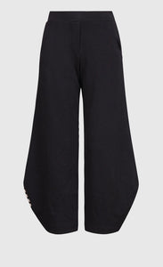 Front view of the alembika urban french terry punto pant. The wide pant is black with an elastic waistband.