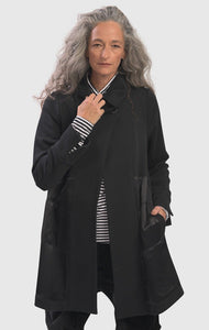 Front close up view of a woman wearing the alembika urban sleek satin trim jacket in black. This jacket has a single button closure and satin panels on the side. 