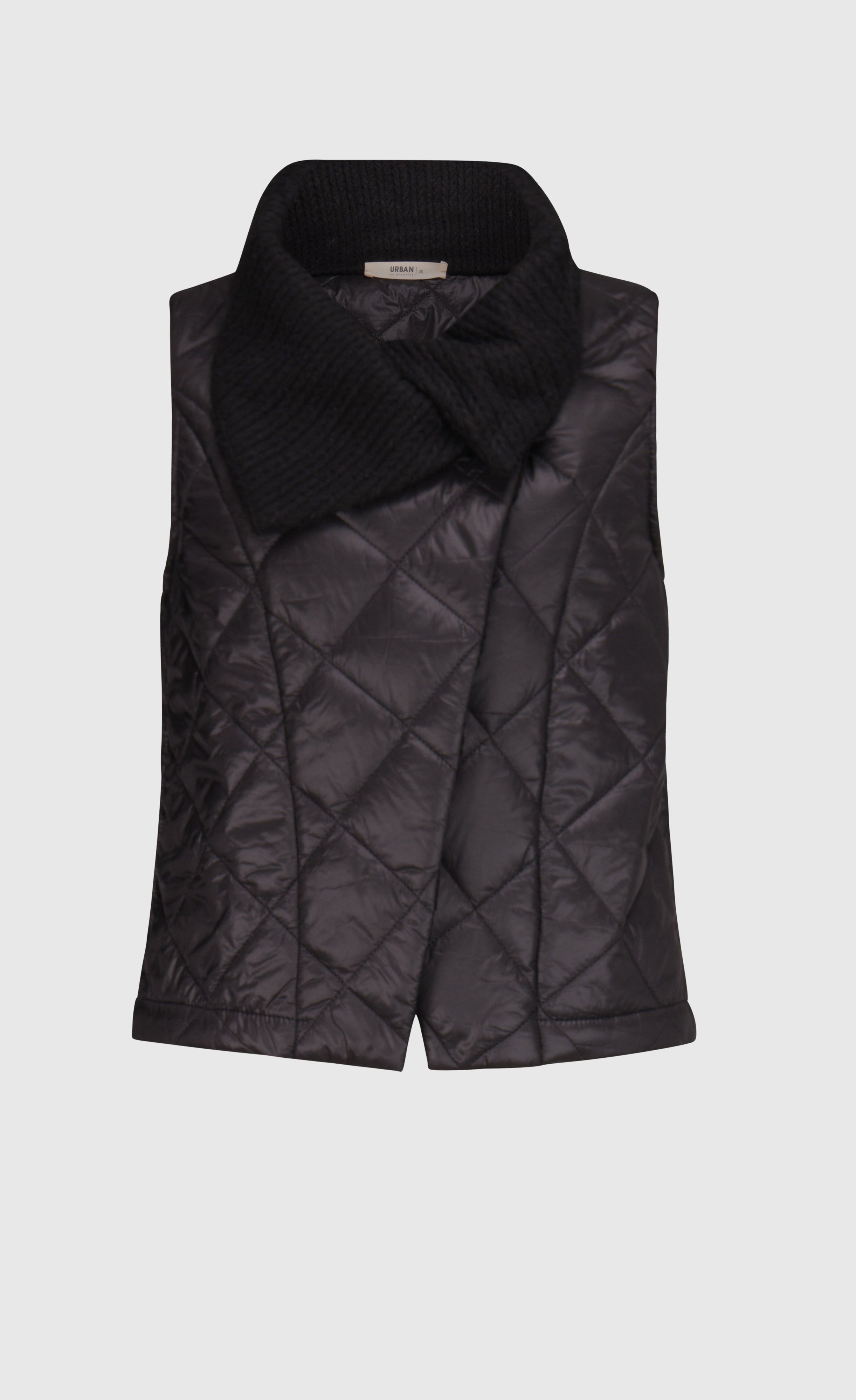 Front view of the alembika urban puffer vest in black. This vest has a ribbed collar and a front single button.