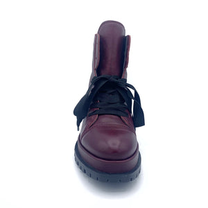 Front view of the all black ankle tie camper boot. This boot has a lug/combat boot look with wide black laces and an ankle length shaft. These boots are wine colored.