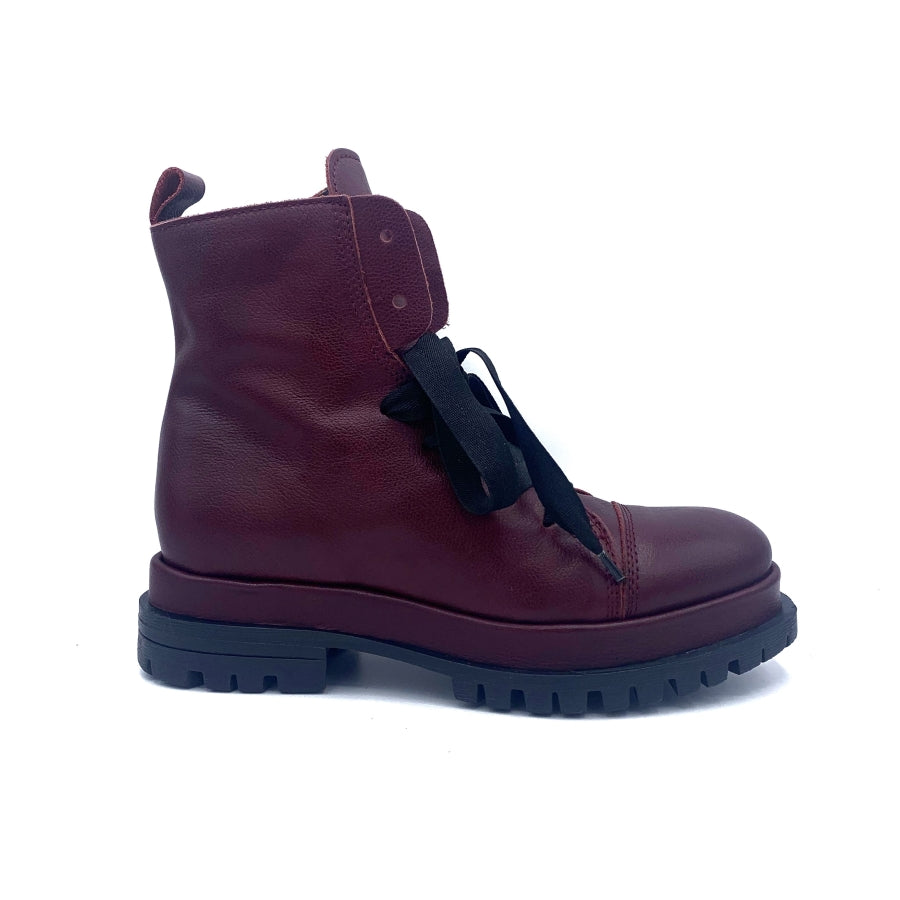 Outer view of the all black ankle tie camper boot. This boot has a lug/combat boot look with wide black laces and an ankle length shaft. These boots are wine colored.