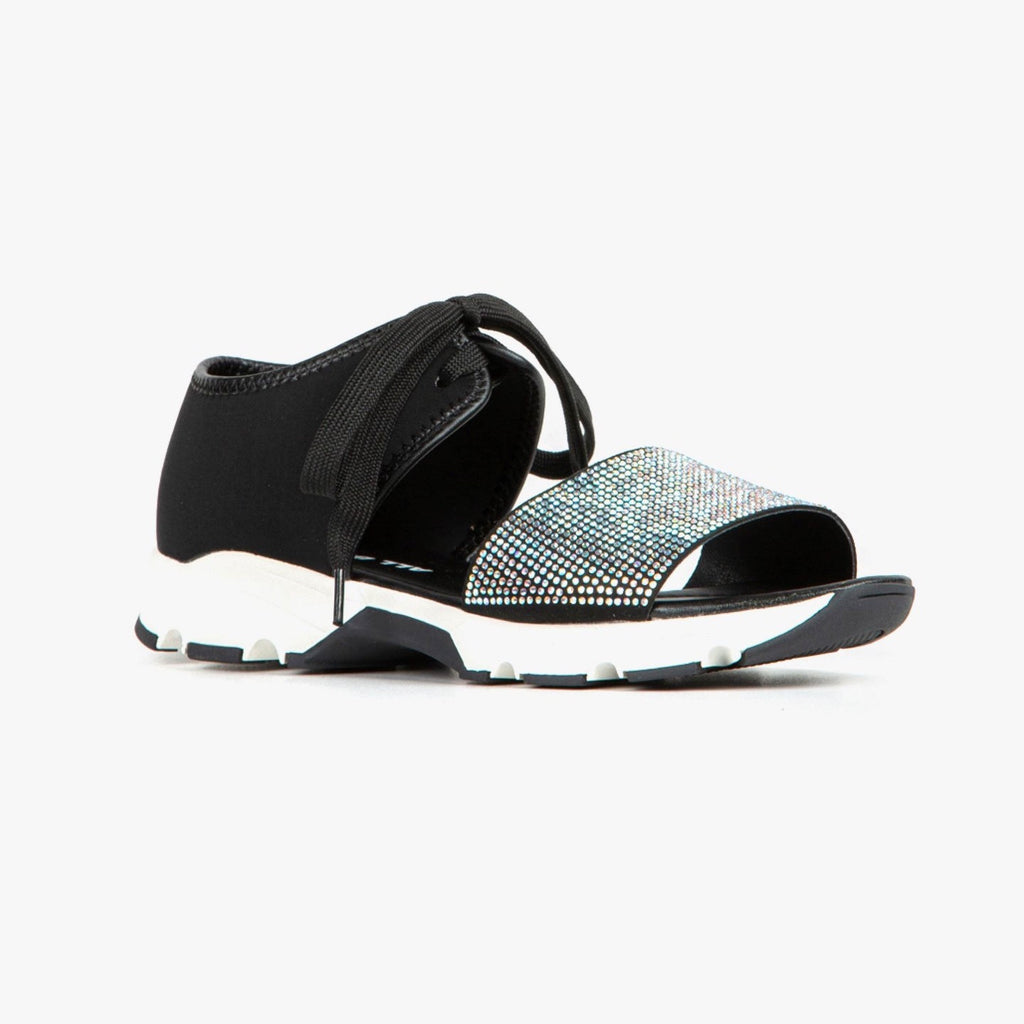 Right side view of the all black banded pave sneaker sandal. This sneaker sandal has a black upper with a shoe lace closure. The upper near the ankle is cut off from the upper that covers the toes. The upper on the toes is detailed with white rhinestones. The shoe is black and white and the front is open toed.