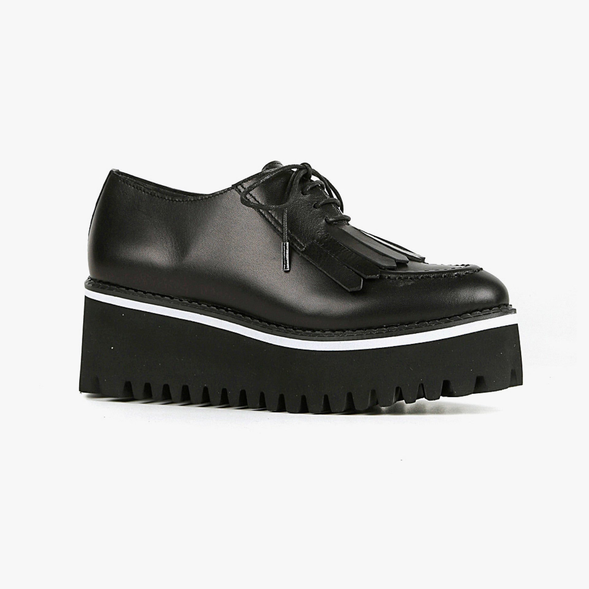 Outer side view of the all black footwear kiltie ox flatform. This shoe is black with a black platform sole and a lace up front. The sole and leather upper are separated by white piping around the shoe.