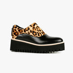 Load image into Gallery viewer, Outer side view of the all black jungle spats flatform shoe. This shoe is black with a cheetah print on the upper. It has a zipper back and a black platform sole detailed with beige piping.
