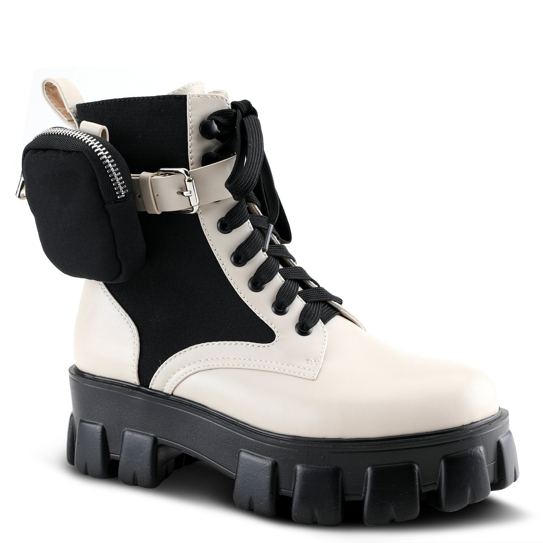 Outer front side view of a azura stoked boot. This boot is beige and black with a black lace up front and a black lug sole. The boot has a decorative strap around the ankle with a mini zip pouch attached. 
