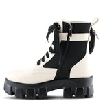 Load image into Gallery viewer, Inner side view of a azura stoked boot. This boot is beige and black with a black lace up front and a black lug sole. The boot has a decorative strap around the ankle and an inner zipper.
