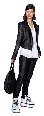 Load image into Gallery viewer, Front full body view of a model wearing the beate heyman carbon jacket and the beate heymann signature jogger. These joggers are black and appear faux leather. They have decorative stitching all over the leg and two front zip pockets.
