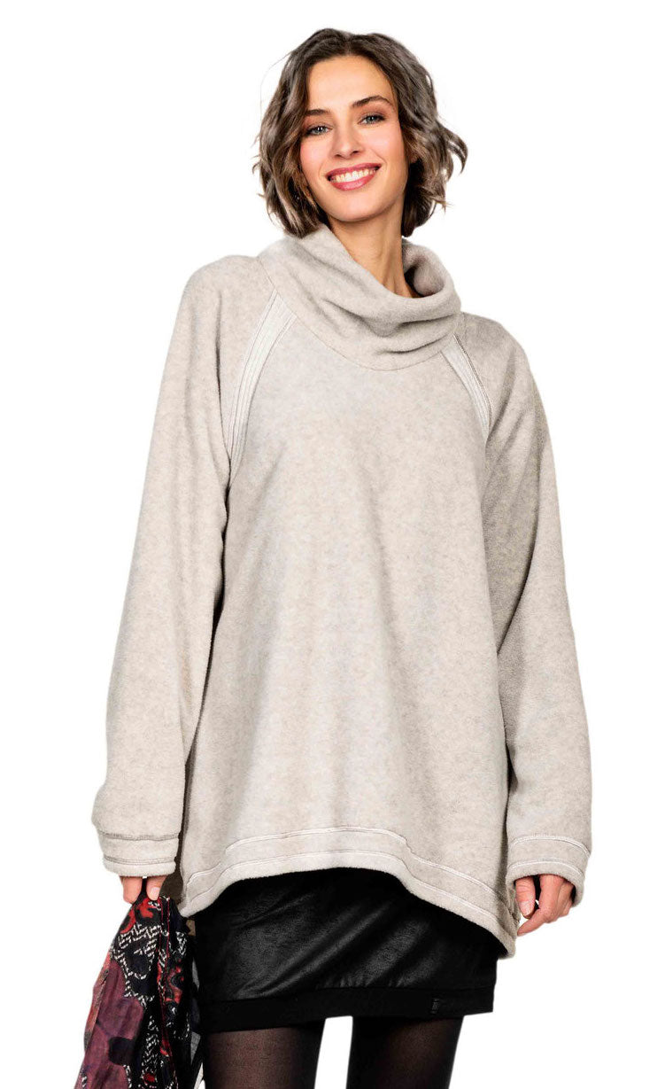 front top half view of a woman wearing the beate heymann fluffy sweatshirt. This sweatshirt is beige colored with a cowl neck, long sleeves, and an oversized fit.
