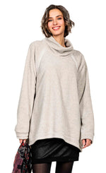 Load image into Gallery viewer, front top half view of a woman wearing the beate heymann fluffy sweatshirt. This sweatshirt is beige colored with a cowl neck, long sleeves, and an oversized fit.
