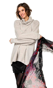 front top half view of a woman wearing the beate heymann fluffy sweatshirt. This sweatshirt is beige colored with a cowl neck, long sleeves, and an oversized fit.