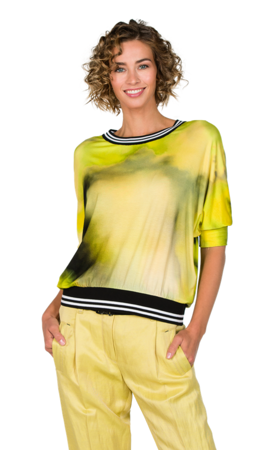 Front top half view of a woman wearing the beate heymann batik lime top. 