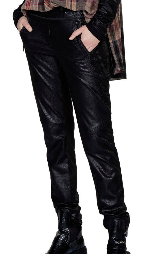 Front bottom half view of a model wearing the beate heymann signature jogger. These joggers are black and appear faux leather. They have decorative stitching all over the leg and two front zip pockets.
