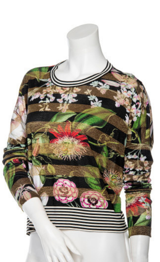 Front top view of a mannequin wearing the Beate Heymann Floral Striped Top. This top is striped black and gold with flowers on top of it. The neck and the hem have black and white striped trim. The top also has long sleeves.