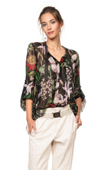 Load image into Gallery viewer, Front top half view of a woman wearing the beate heymann floralis blouse. This top is black with a floral print and transparent. It has long sleeves and a v-neck.
