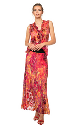 Load image into Gallery viewer, Front full body view of a woman wearing the beate heymann fuchsia firewall skirt. This skirt has a mixed print of pink, red, and orange. It is slim but relaxed and flowy. The skirt ends at the ankle.
