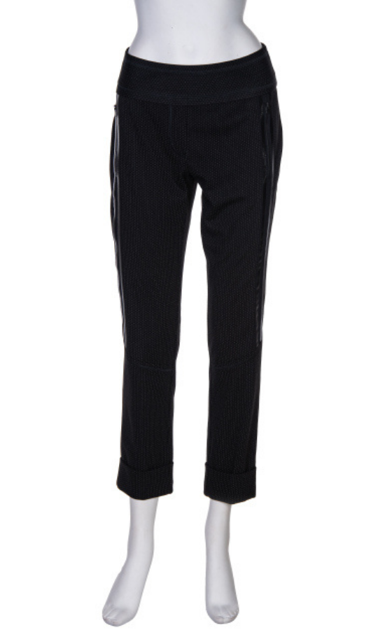 Front view of the beate heymann dotted pant. This pant is black with small white/grey dots on it. The pant has shiny black side striping and zipped side pockets. The bottom of the pants are cuffed.
