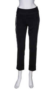 Front view of the beate heymann dotted pant. This pant is black with small white/grey dots on it. The pant has shiny black side striping and zipped side pockets. The bottom of the pants are cuffed.