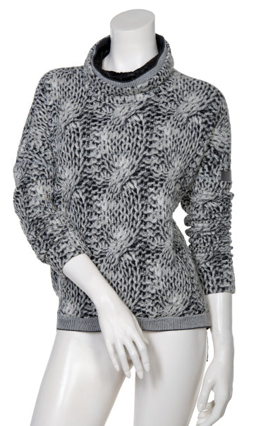 Front view the beate heymann chunky knit pullover. This top has long sleeves, a mock neck with black lining, and a grey, loose knit appearance.