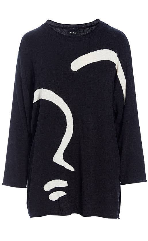 front view of the bitte kai rand bloom knit blouse with face. this top is black with a large white abstract sketch of a face on it. The top has long sleeves and a round neck. 