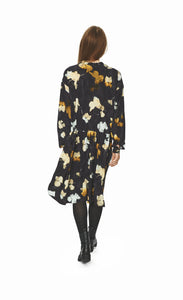 Back full body view of a woman wearing the bitte kai rand falling leaves dress. This dress is dark grey with mustard and light blue colored leaves all over. The dress has long sleeves and a seam at the waist.