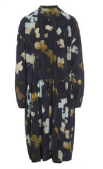 Load image into Gallery viewer, Back view of the bitte kai rand falling leaves dress. This dress is dark grey with mustard and light blue colored leaves all over. The dress has long sleeves and a seam at the waist.
