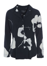 Load image into Gallery viewer, Front view of the bitte kai rand oki flower shirt. This shirt is black with large white flowers. It has a button down front, long sleeves, and a form-fitting silhouette.
