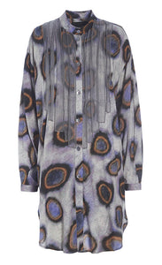 Front view of the bitte kai rand sea shirt. This purple/grey shirt has circular print on it in purple and orange and strips of organza coming from the shoulders and neck like a bib of ribbons. The shirt has a button down front and a curved hem.