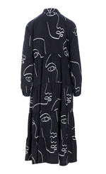 Load image into Gallery viewer, Back view of the bitte kai rand sketch viscose long dress. This dress is black with white sketches of faces all over it. The dress has long sleeves and a ruffled bottom half.
