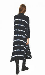 Load image into Gallery viewer, Back full body view of a woman wearing the bitte kai rand suki shibori shirt dress. This long dress is black with tie-dyed lines. It has long sleeves and a relaxed fit.
