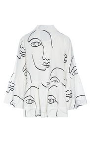 Back view of the bitte kai rand sketch viscose shirt jacket. This shirt is white with black sketch faces on it. It has long sleeves with ruffles and a ruffles on the bottom half of the top.