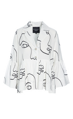 Load image into Gallery viewer, Front view of the bitte kai rand sketch viscose shirt jacket. This shirt is white with black sketch faces on it. It has a two button up front, a notched collar, long sleeves with ruffles, and a ruffles on the bottom half of the top.
