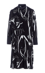 Load image into Gallery viewer, Front view of the bitte kai rand tulip tango shirt dress. This dress is black with black and white tulip flowers all over it. The dress has a button up front and 3/4 length sleeves. 

