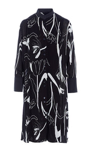 Front view of the bitte kai rand tulip tango shirt dress. This dress is black with black and white tulip flowers all over it. The dress has a button up front and 3/4 length sleeves. 
